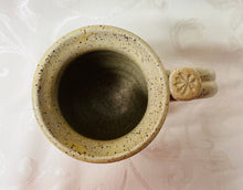 Load image into Gallery viewer, A Mug:  (Beige Ceramic Mug on Speckled Clay with a Symbol Thumb Rest)