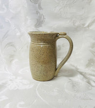 Load image into Gallery viewer, A Mug:  (Beige Ceramic Mug on Speckled Clay with a Symbol Thumb Rest)