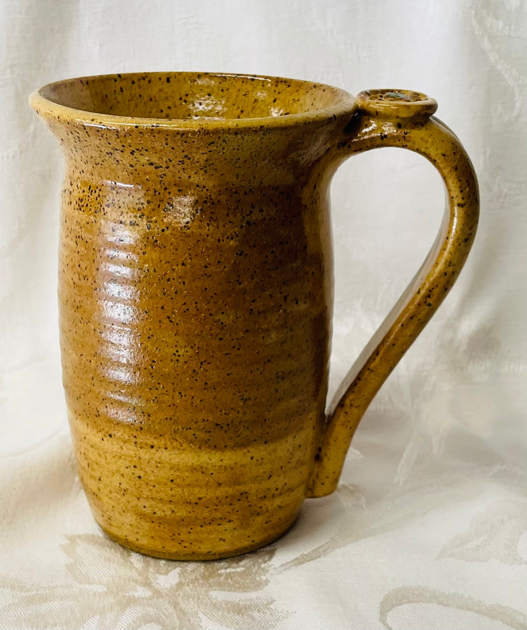 A Mug:  (Goldenrod on Speckled Clay with a Daisy Thumb Rest)