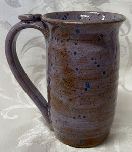 A Mug:  (Brown/Purple with Blue Spots and a Flower Thumb Rest)