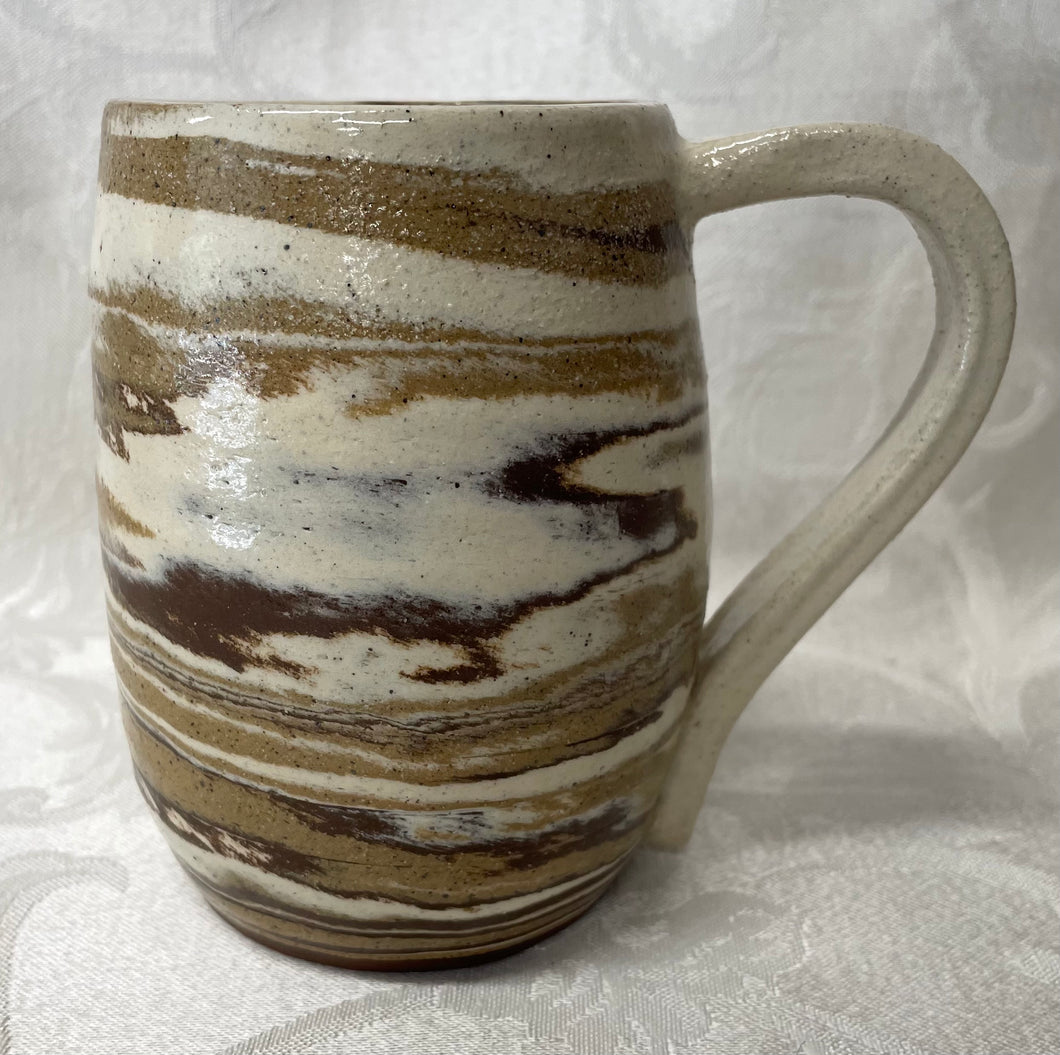 A Mug:  (Tri Colored Ceramic Clay Mug with a Turtle Stamp on the Handle Bottom)