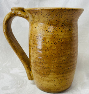 A Mug:  (Goldenrod Ceramic Mug on Speckled Clay with a Daisy Thumb Rest)