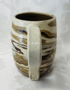 A Mug:  (Tri Colored Ceramic Clay Mug with a Turtle Stamp on the Handle Bottom)