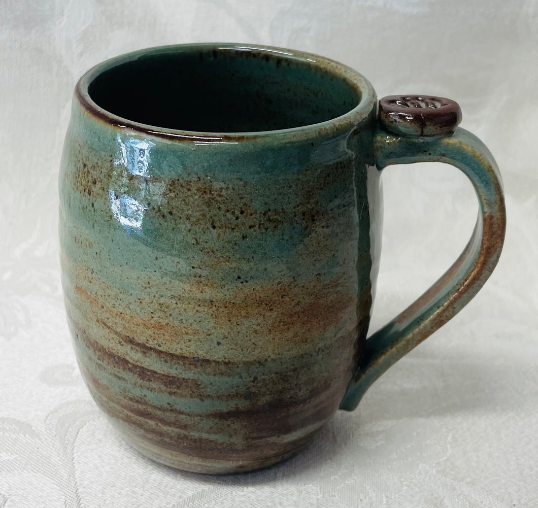 A Mug:  (Desert Sage Green Ceramic Mug with a Leaf Thumb Rest)