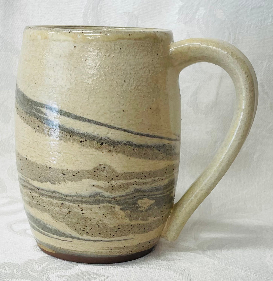 A Mug:  (Off-White Ceramic Mug on Tri-Colored Clay)