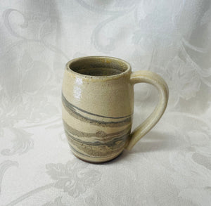 A Mug:  (Off-White Ceramic Mug on Tri-Colored Clay)
