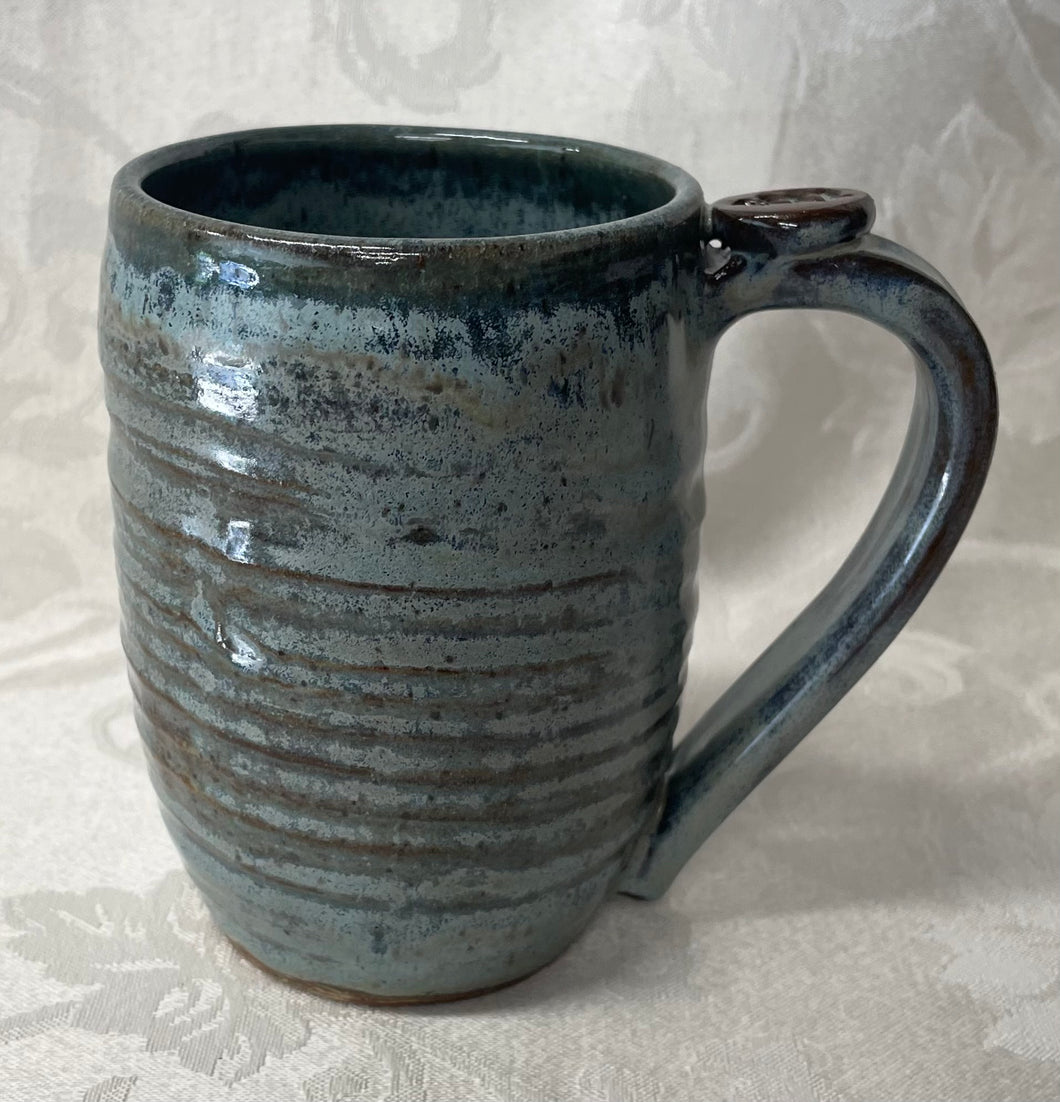 A Mug:  (Ice Green Ceramic Mug with a Leaf Thumb Rest)