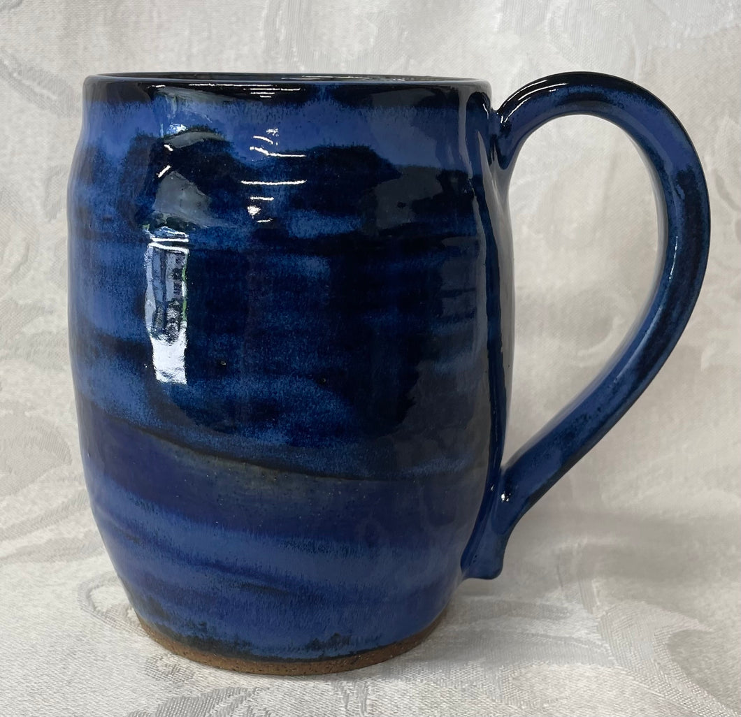 A Mug:  (Azure Blue Ceramic Mug with a Paw Print Stamp on the Handle Bottom)