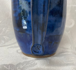 A Mug:  (Azure Blue Ceramic Mug with a Paw Print Stamp on the Handle Bottom)