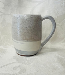 A Mug:  (White Ceramic Mug on Tri-Colored Clay with a Leaf Stamp on the Handle Bottom)