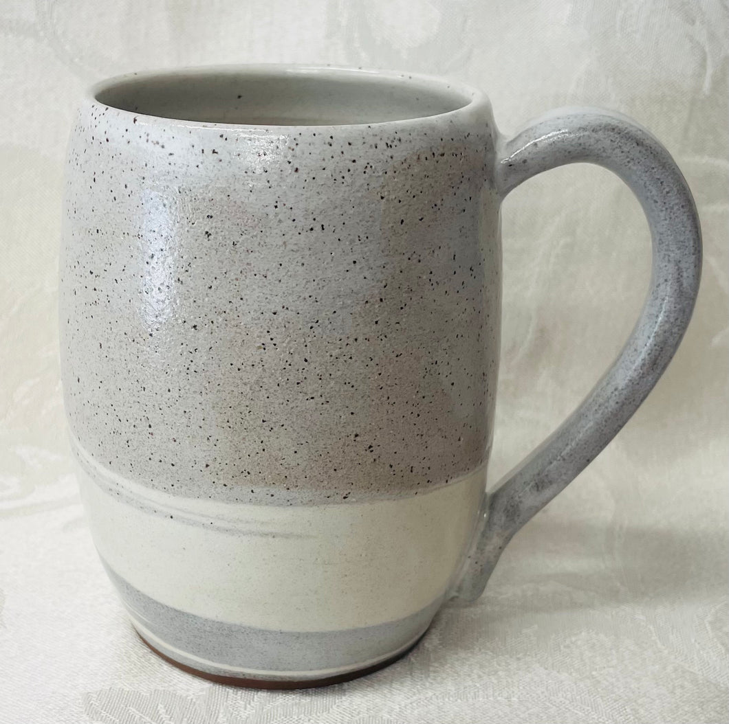 A Mug:  (White Ceramic Mug on Tri-Colored Clay with a Leaf Stamp on the Handle Bottom)