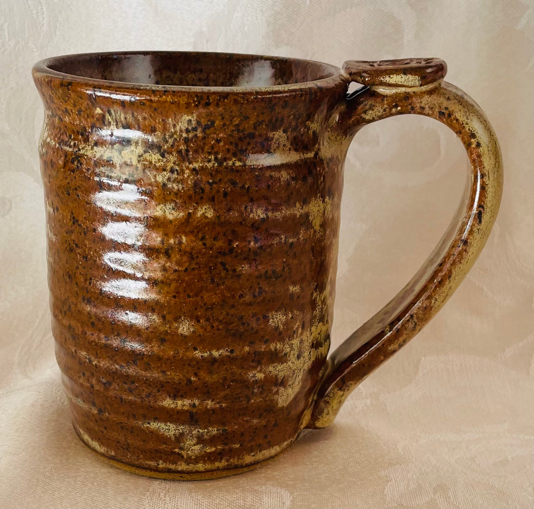 A Mug:  (Brownish-Beige on Speckled Clay with a Turtle Thumb Rest)