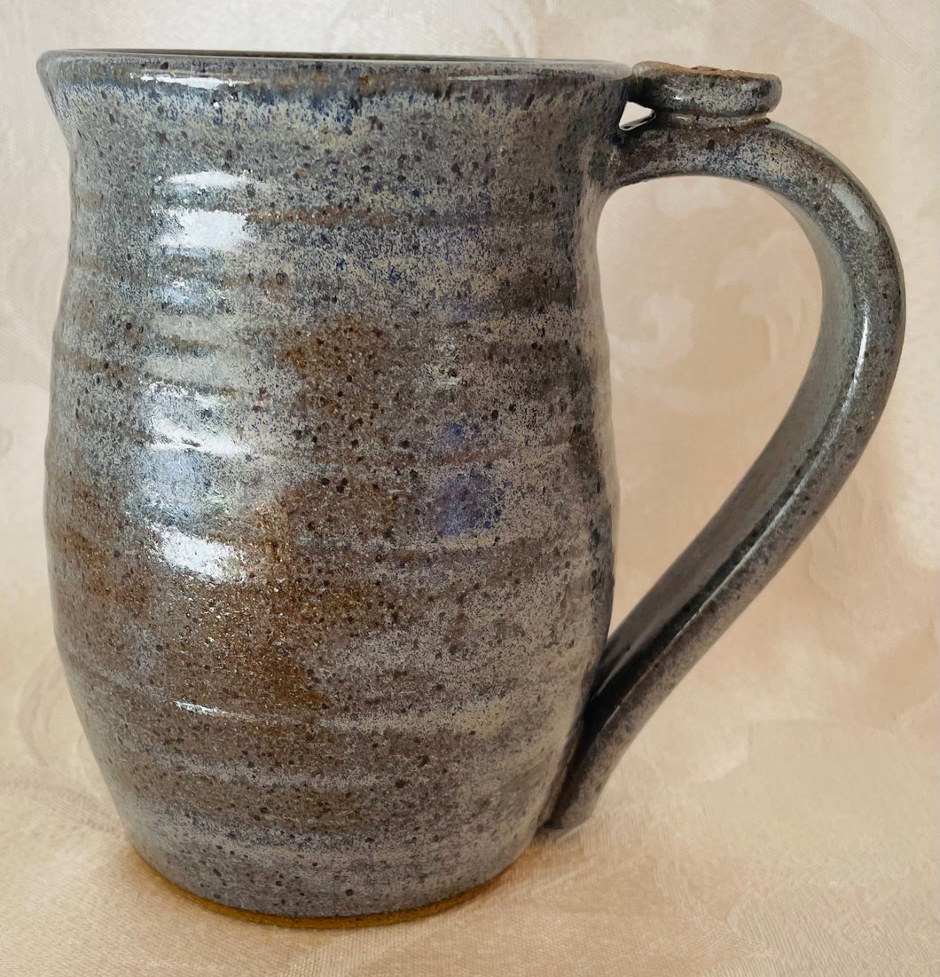 A Mug:  (Light Blue on Speckled Clay with a Star Thumb Rest)